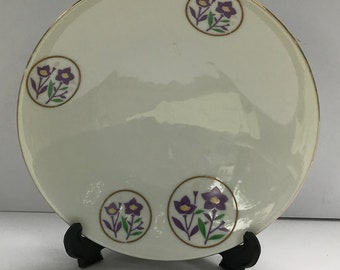 Vintage 7.5” ceramic bowl with purple flower design Japan.