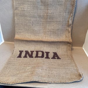 May include: A handmade wooden sign with the text "Welcome" in a playful font. The sign features a distressed white background and a dark stained wooden frame, perfect for a front door or entryway.