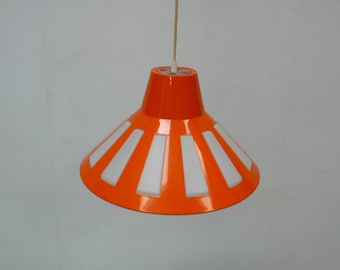 May include: Orange and white pendant light with a cone-shaped shade and white vertical panels.