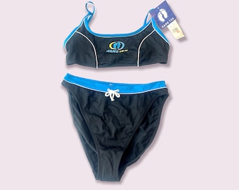 May include: Black bikini swimsuit with blue trim and the logo "Hang Ten" on the top. The bikini top has a racerback style and the bottoms have a tie at the waist.