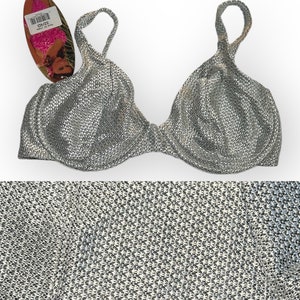 May include: Silver metallic bra with adjustable straps. The bra has a textured, woven fabric.