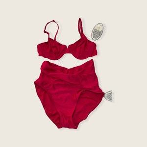May include: A red two-piece swimsuit with a high-waisted bottom and a halter top.
