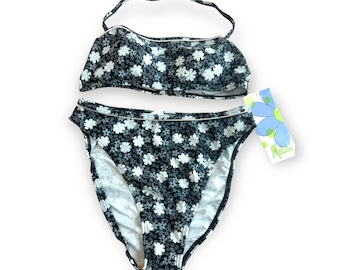 May include: Black and white floral print bikini with a halter top and high-waisted bottoms. The bikini is new with tags and the tag says "Marina".