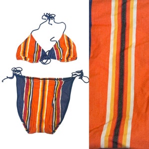 May include: A striped bikini swimsuit with a blue and orange color scheme. The top is a triangle style and the bottom is a high-cut style.