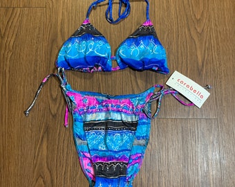 May include: A blue and pink patterned bikini with a halter top and a tie-side bottom. The bikini is made by the brand "Carabella Collections".