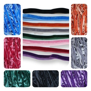 May include: Assortment of velvet ribbon in various colors, including black, blue, red, green, pink, gray, and purple. The ribbon is arranged in rows, with each color displayed in a separate section.