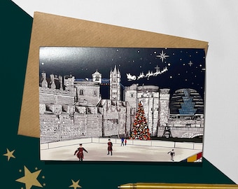 May include: A Christmas card featuring a black and white illustration of the Tower of London with a Christmas tree and ice skaters in front of it. The sky is dark blue with stars and a white silhouette of Santa Claus flying in a sleigh with reindeer.
