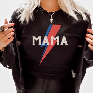 May include: Black t-shirt with a red, blue, and white lightning bolt graphic and the word "MAMA" printed on the front.