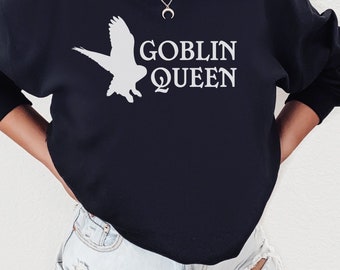 May include: A black sweatshirt with a white owl graphic and the text "Goblin Queen" printed on the front.