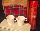 Vintage Thermos Picnic Set with Bag, 1 quart Thermos Bottle, Sandwich Box, 2 Plastic Mugs, and bonus stopper. Item used but good condition.