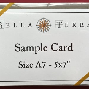 May include: A white card with a compass design and the text "BELLA TERRA" in black. The card also says "Sample Card" and "Size A7 - 5x7" in black.