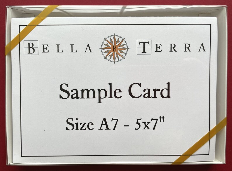 May include: A white card with a compass design and the text "BELLA TERRA" in black. The card also says "Sample Card" and "Size A7 - 5x7" in black.