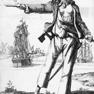 May include: A black and white engraving of a woman pirate holding a pistol and a sword. She is wearing a hat and a jacket, and her hair is long and flowing. She is standing on a beach with a ship in the background.