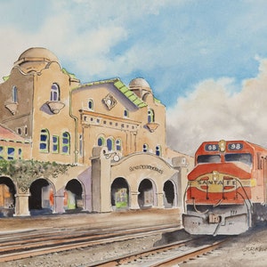 May include: A watercolor painting of a red and white Santa Fe train engine pulling into a train station. The station is a large, brown building with arched doorways and a sign that reads "Santa Fe Railway".