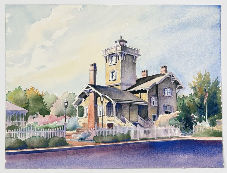 May include: Watercolour painting of a historic building with a tower, set against a blue sky. The building is painted in shades of yellow and grey, with a white picket fence and lush greenery in the foreground. A flag waves in the distance.