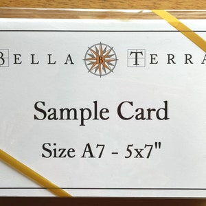 May include: A white card with a compass design and the text "BELLA TERRA" at the top. The text "Sample Card" is in the center of the card and the text "Size A7 - 5x7" is at the bottom of the card.