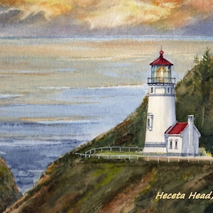 May include: Watercolor painting of Heceta Head Lighthouse in Oregon. The white lighthouse with a red roof sits on a green hillside overlooking the ocean. The sky is a mix of orange, yellow, and blue.