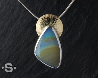 Opal pendant set in silver and gold. Real opal jewelry. Precious opal.