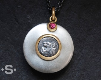 Pendant, ancient Greek coin. Coin pendant. Silver, gold 750, red sapphire. Goldsmith's work - unique. Astrological sign Leo.