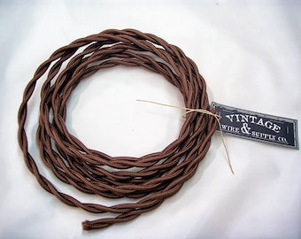 May include: Brown twisted electrical cord with a tag that reads "Vintage Wire & Supply Co."