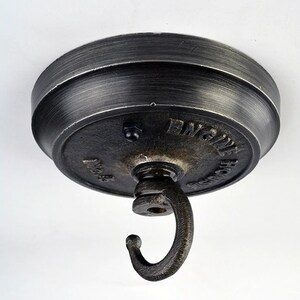 May include: A black metal ceiling hook with a round base and a hook. The base has the words "Engine House" and "No. 8" embossed on it.