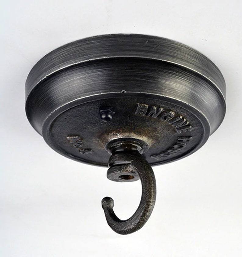May include: A black metal ceiling hook with a round base and a hook. The base has the words "Engine House" and "No. 8" embossed on it.