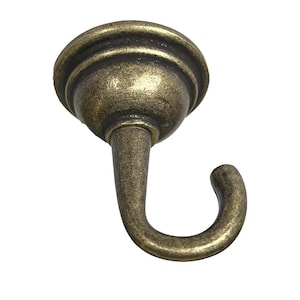 May include: Antique gold-toned metal hook with a decorative top. The hook is designed for hanging light fixtures.