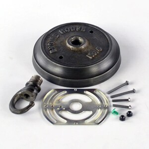 May include: A black metal ceiling fixture kit with a round base, a hook, a metal plate, and screws. The base has the text "EICHE HOUSE" and "120.15" on it.