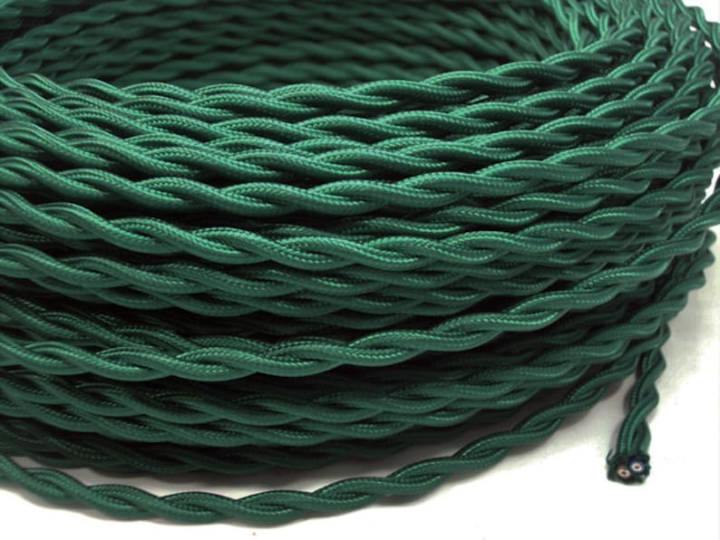 May include: A spool of dark green twisted electrical cord. The cord is made of fabric and has a two-pin plug.