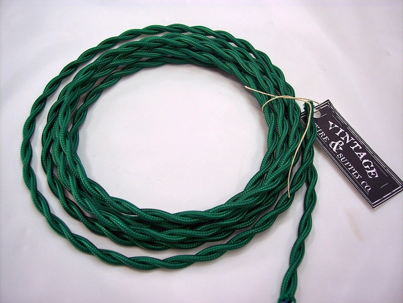 May include: A spool of green twisted electrical wire with a black and white tag that reads "Vintage & Supply Co."