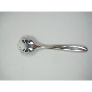 May include: A silver-colored spoon with a scalloped bowl and a long, slender handle. The spoon is made of a shiny, reflective metal, likely stainless steel or silver. The design is simple and elegant, suitable for serving sugar or other condiments.