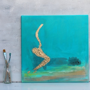 May include: Abstract painting on canvas with a turquoise background and a gold leaf design. The painting has a textured surface and a subtle green and brown color at the bottom.