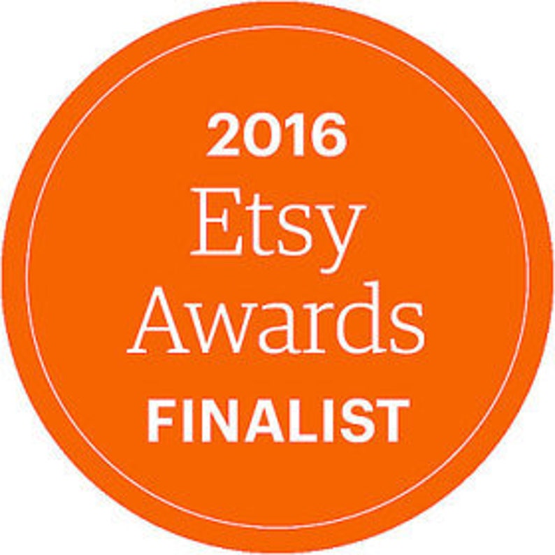 May include: Orange circle with white text that reads "2016 Etsy Awards FINALIST".