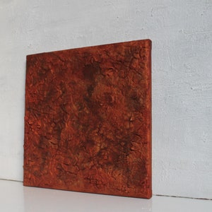 Può includere: Un dipinto astratto testurizzato su tela con uno schema di colori arancione ruggine e marrone.