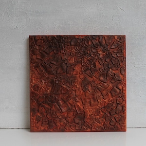 Può includere: Dipinto astratto con una superficie testurizzata. Il dipinto è di forma quadrata e presenta una gamma di colori marroni e arancioni.