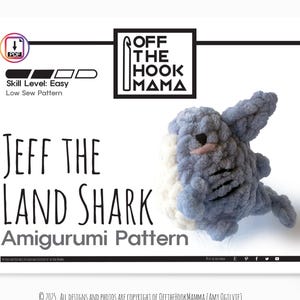 May include: A white background features a plush, gray and white shark amigurumi. The text "JEFF THE LAND SHARK Amigurumi Pattern" is displayed. The "Off The Hook Mama" logo is in the upper right corner. The skill level is easy.