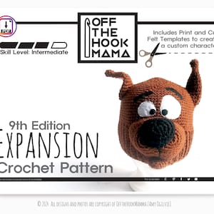 May include: Crochet pattern for a 9th edition expansion, featuring a brown crocheted dog head with black eyes and nose. The pattern includes print and cut felt templates to create a custom character. The pattern is labelled "Off the Hook Mama" and is for an intermediate skill level.