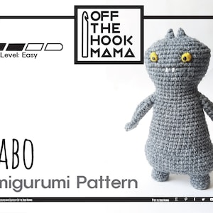 May include: A crochet amigurumi pattern for a grey monster with yellow eyes. The pattern is titled "BABO Amigurumi Pattern" and is labelled as "Easy" skill level. The pattern is available as a PDF download from Off The Hook Mama.