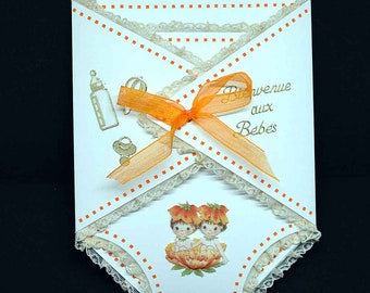 Carte de naissance jumeaux en 3D en forme de  lange blanche motif bébés jumeaux dans fleurs orange et dentelle orangée