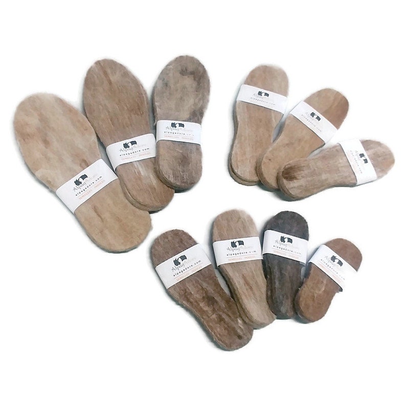 May include: A set of 10 alpaca wool insoles in various sizes. The insoles are made of natural alpaca wool and are designed to provide comfort and support for your feet. The insoles are packaged in a simple white paper with the company logo and website address.
