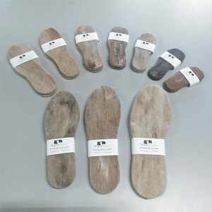 May include: A collection of 12 brown alpaca wool insoles. The insoles are made by Alpaca Amore and are available in a variety of sizes. The insoles are designed to be comfortable and supportive, and they are perfect for people who spend a lot of time on their feet.