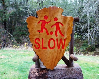 CHILDREN PLAYING SLOW on a rustic National Park shaped arrowhead, street road home cabin camp sign. Carved routed lettering & symbol SOS606+