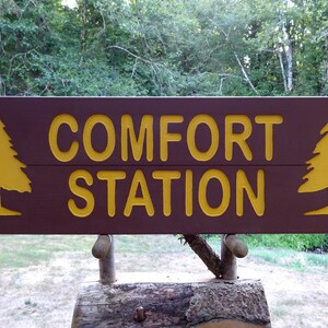 COMFORT STATION sign, park style relaxation retreat road cabin lodge campground. Carved routed painted reflective lettering & trees MAN023F+
