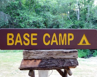 BASE CAMP sign with camping symbol, park style porch trail road cabin campground. Carved routed painted reflective letters & symbol MAN151A+