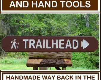TRAILHEAD with hiker and arrowhead, park style path hiking trail cabin campground sign. Carved routed reflective lettering & symbols MN002Nx