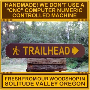 TRAILHEAD with hiker and arrowhead, park style path hiking trail cabin campground sign. Carved routed reflective lettering & symbols MN002Nx