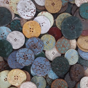 Two button minimum. Hand made high fired ceramic buttons in assorted colors.  Very strong.  Hand wash only. Most buttons are 1 1/2 inches.
