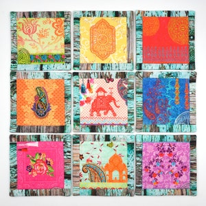 May include: Nine colorful coasters with a variety of patterns, including paisley, floral, and geometric designs. The coasters are made of fabric and have a wooden frame.