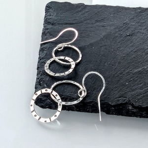 Silver sun design hoop drop earrings