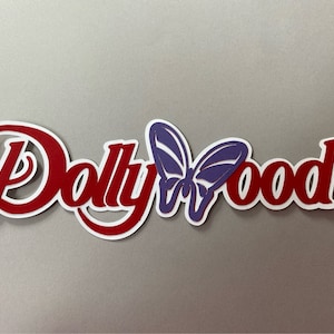 May include: Red and white cutout letters spelling "Dollywood" with a purple butterfly in the center.